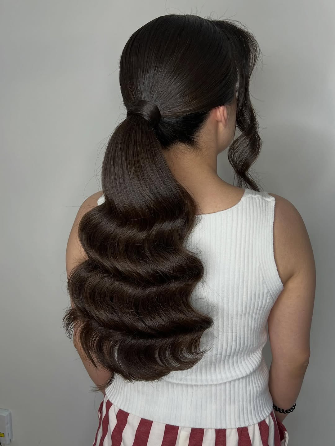 Sleek High Ponytail with Glamorous Waves