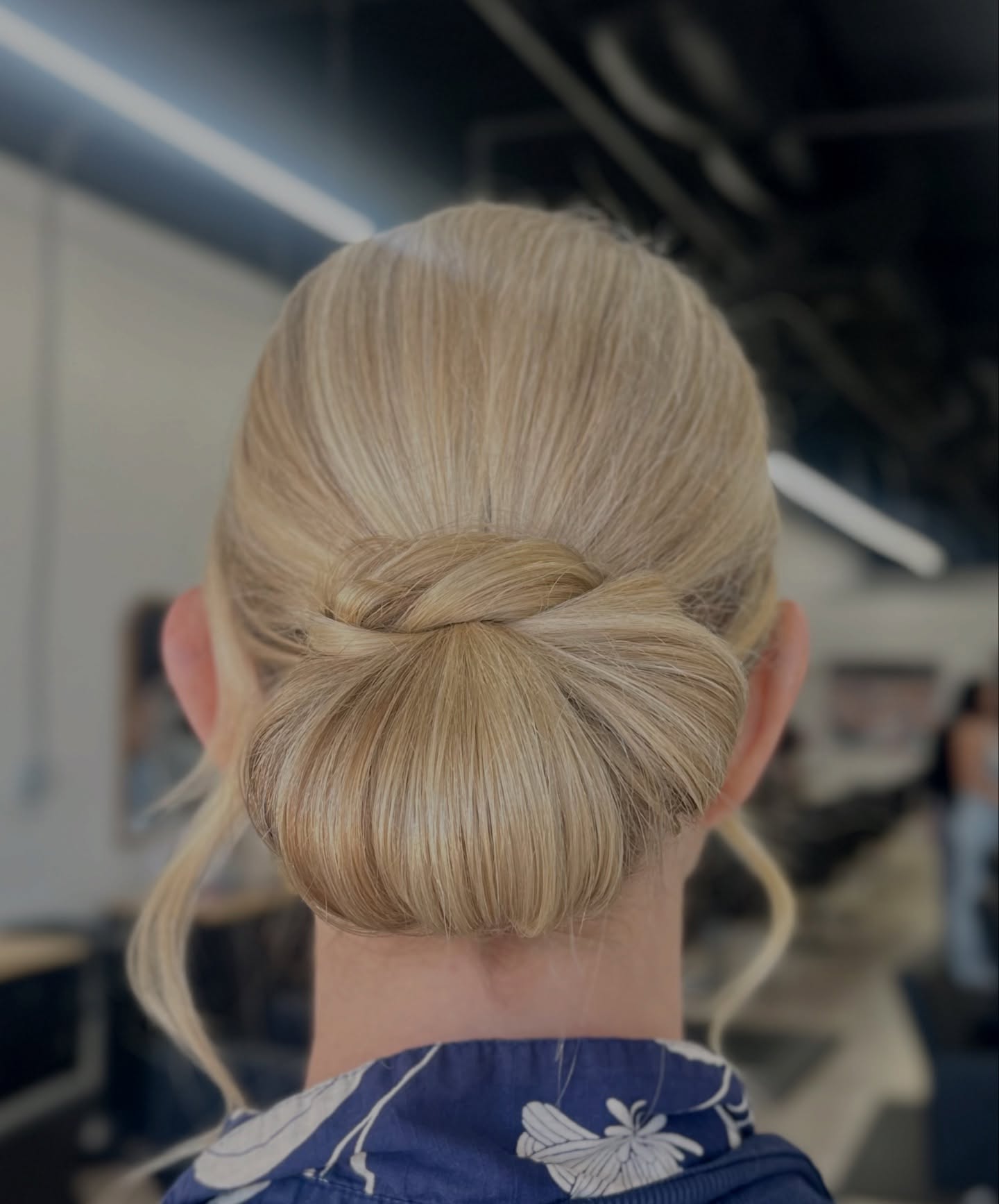 Sleek Twisted Low Bun with Subtle Face-Framing Strands