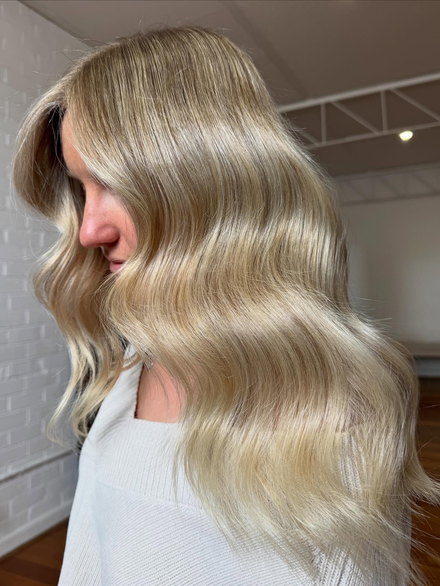 Softly Textured Bright Blonde Waves with a Modern Twist