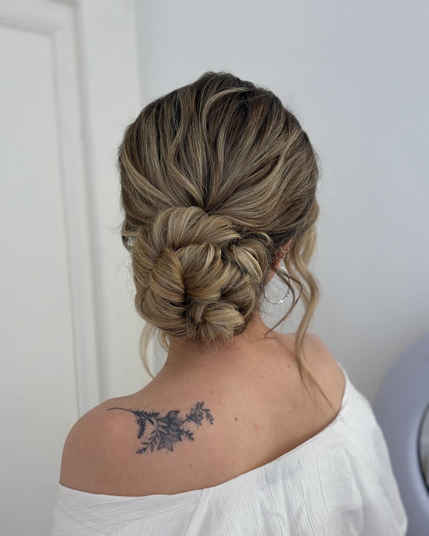 Textured Low Chignon with Loose Tendrils