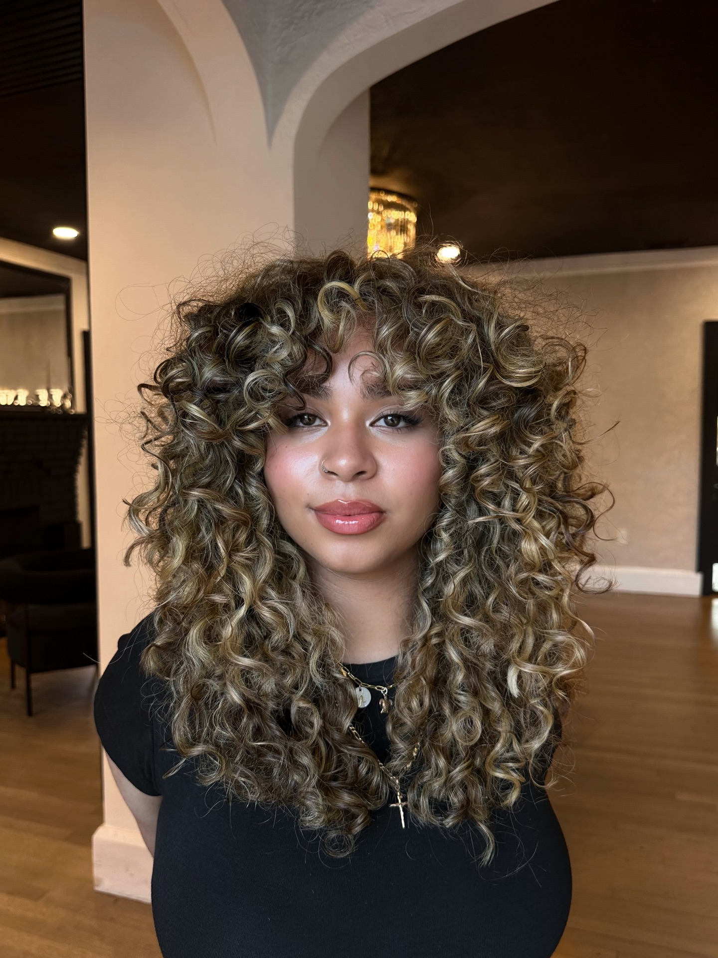 Bold Curly Layers with Sun-Kissed Highlights