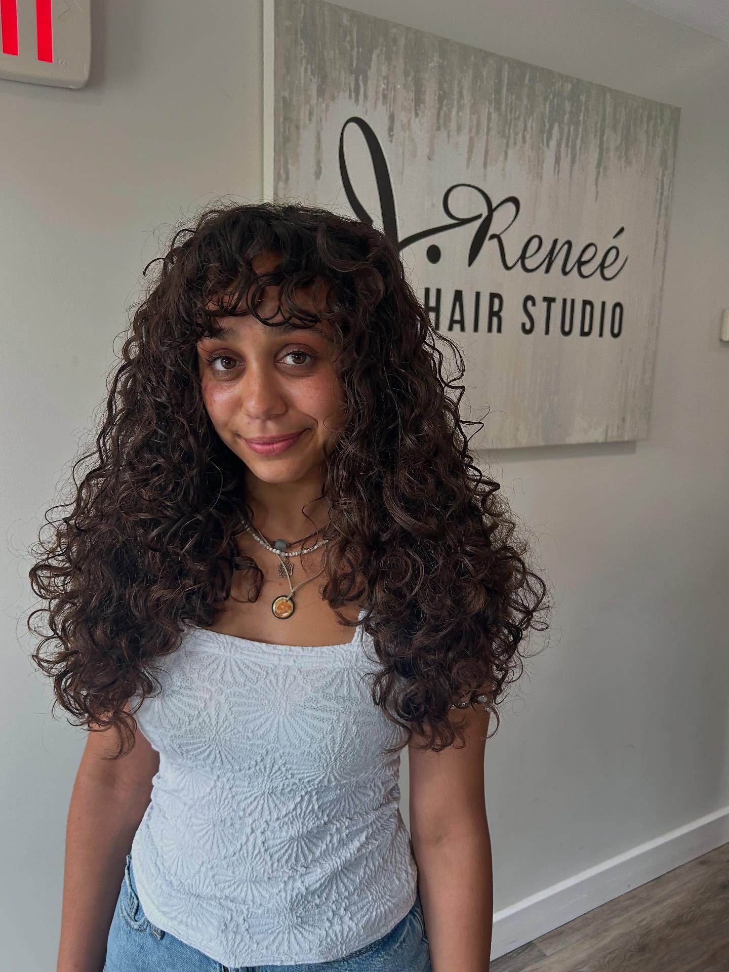 Charming Curly Layers with Soft Bangs
