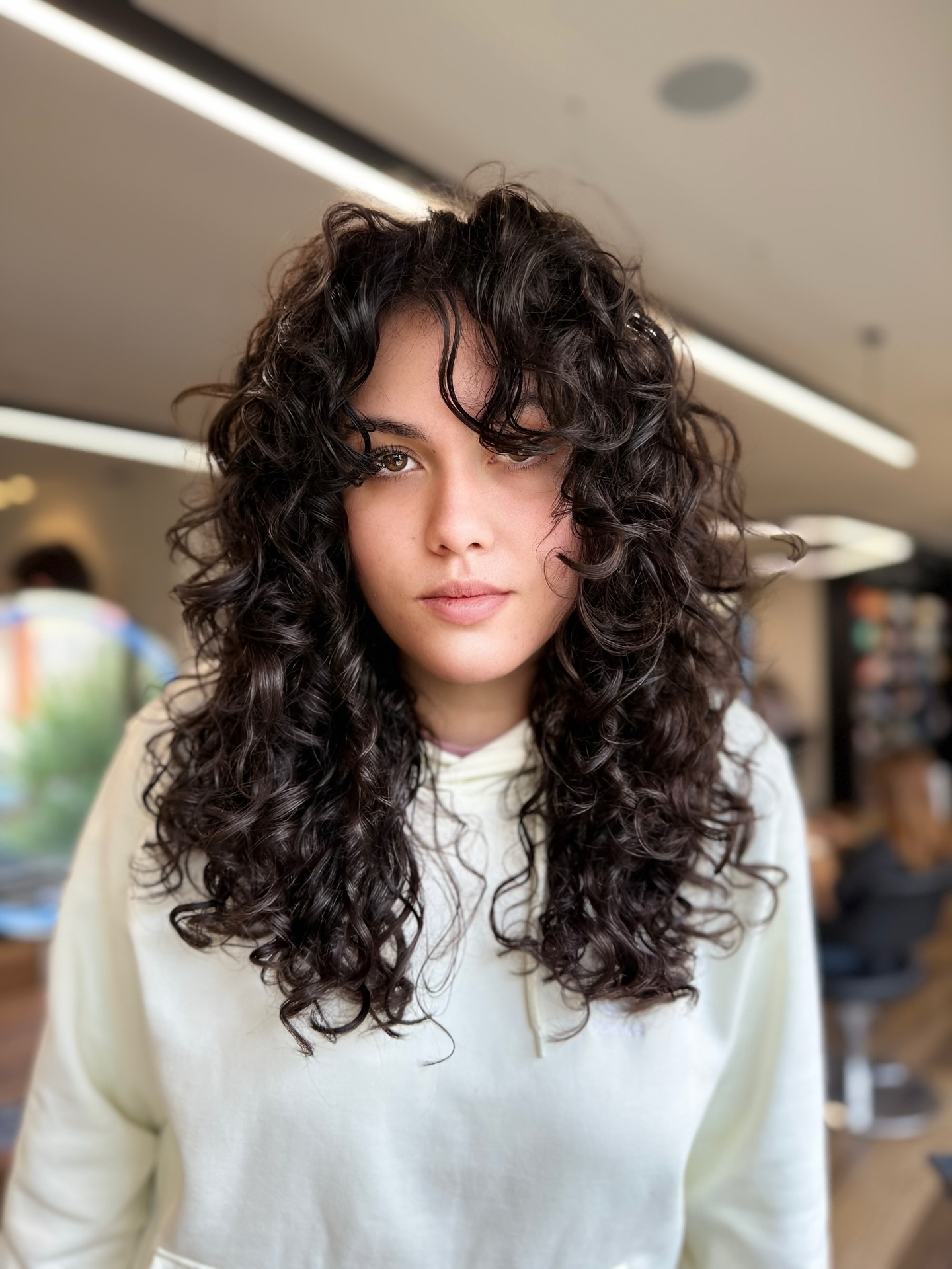 Textured Curly Layers with Face-Framing Highlights