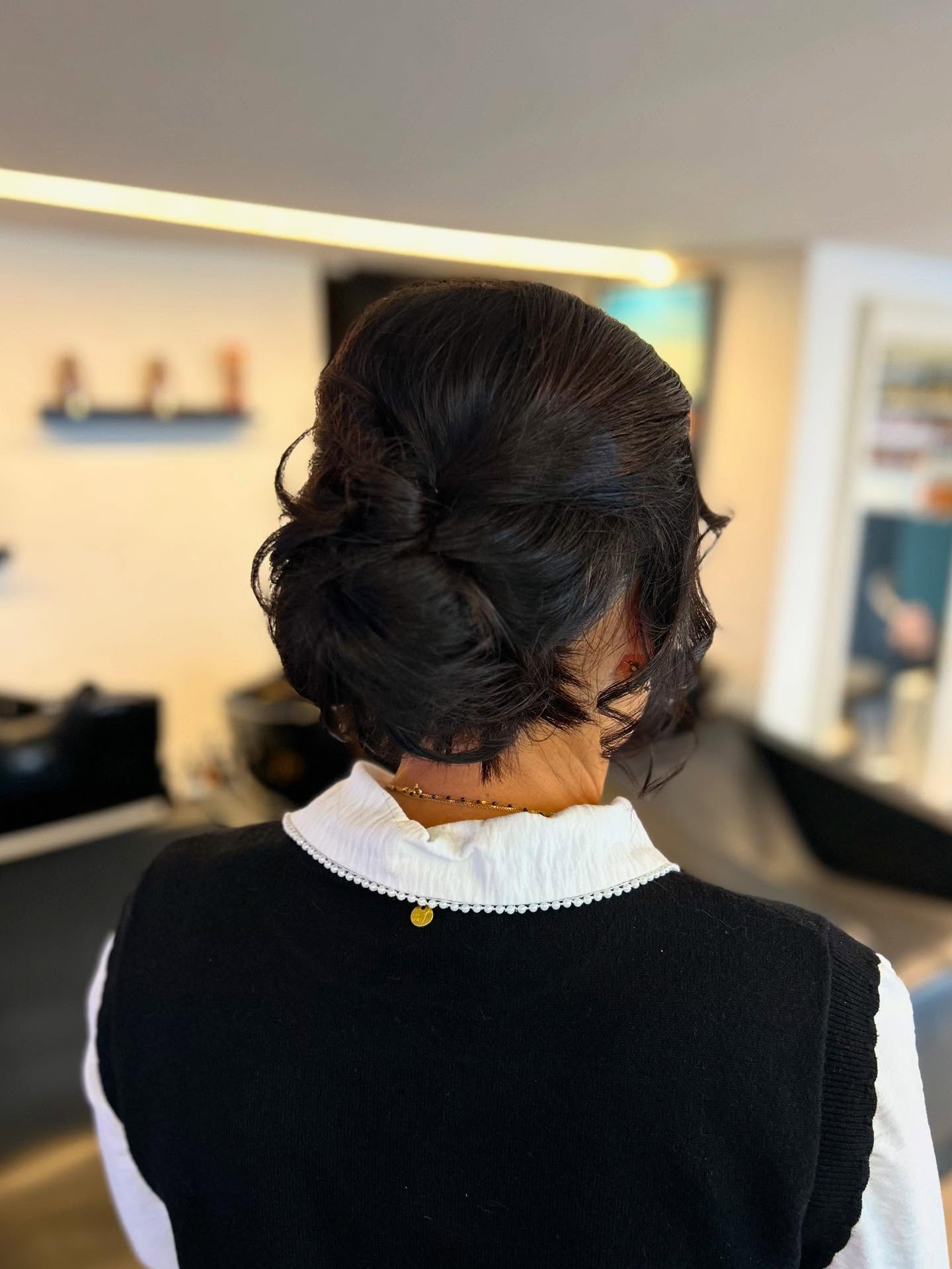 Elegant Textured Low Bun with Soft Curls