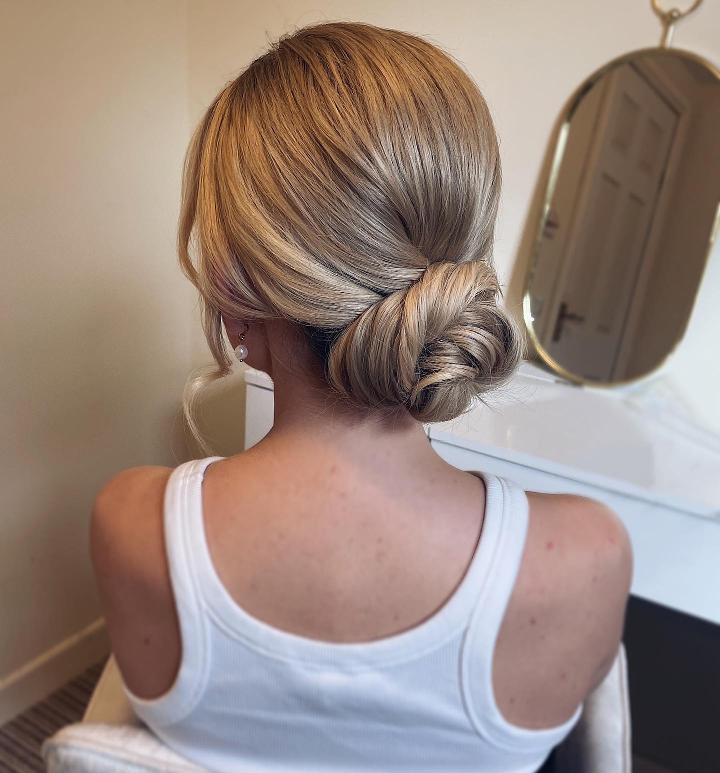 Elegant Twisted Low Bun with Soft Face-Framing Strands