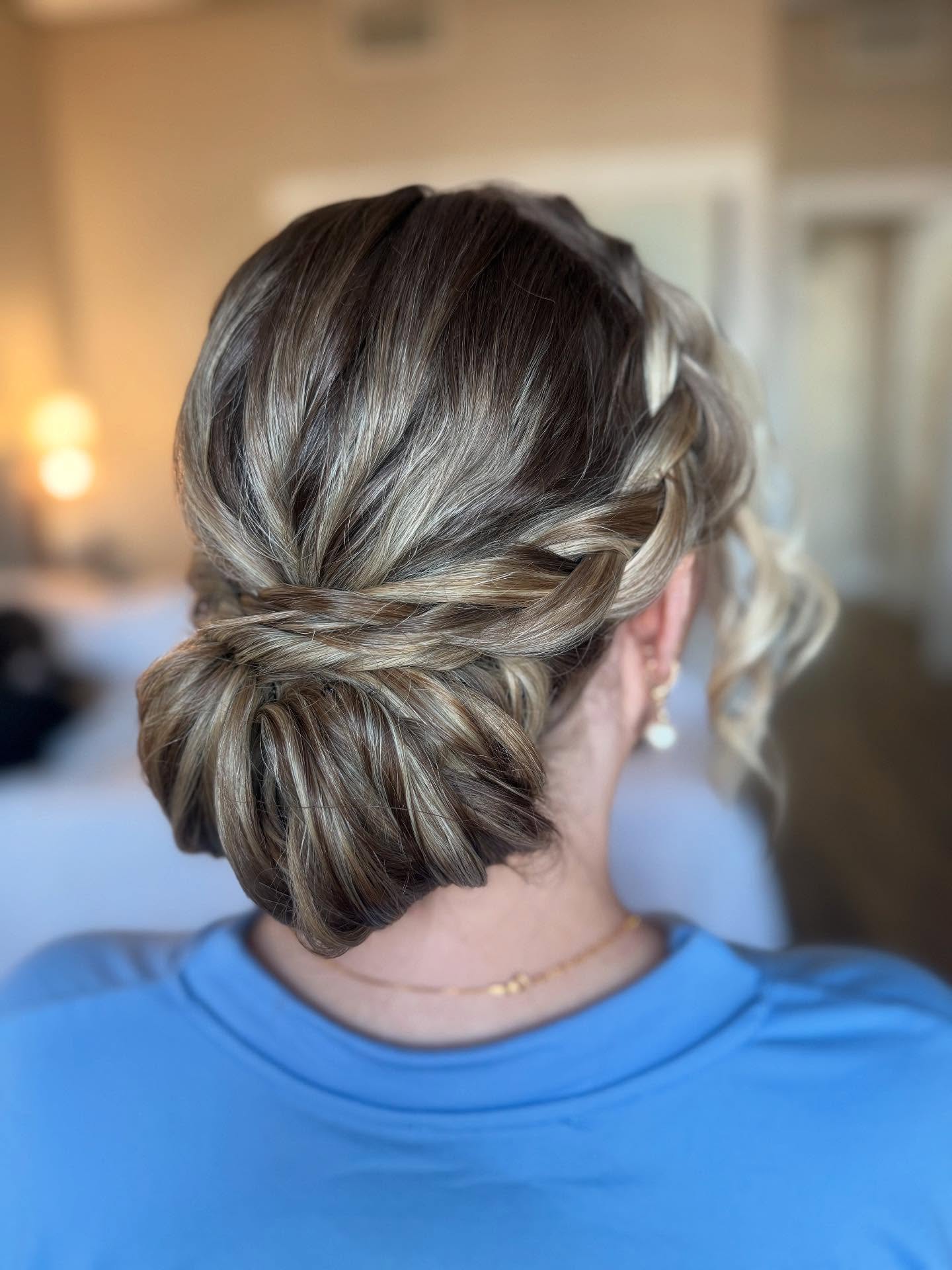Elegant Twisted Low Chignon with Subtle Highlights
