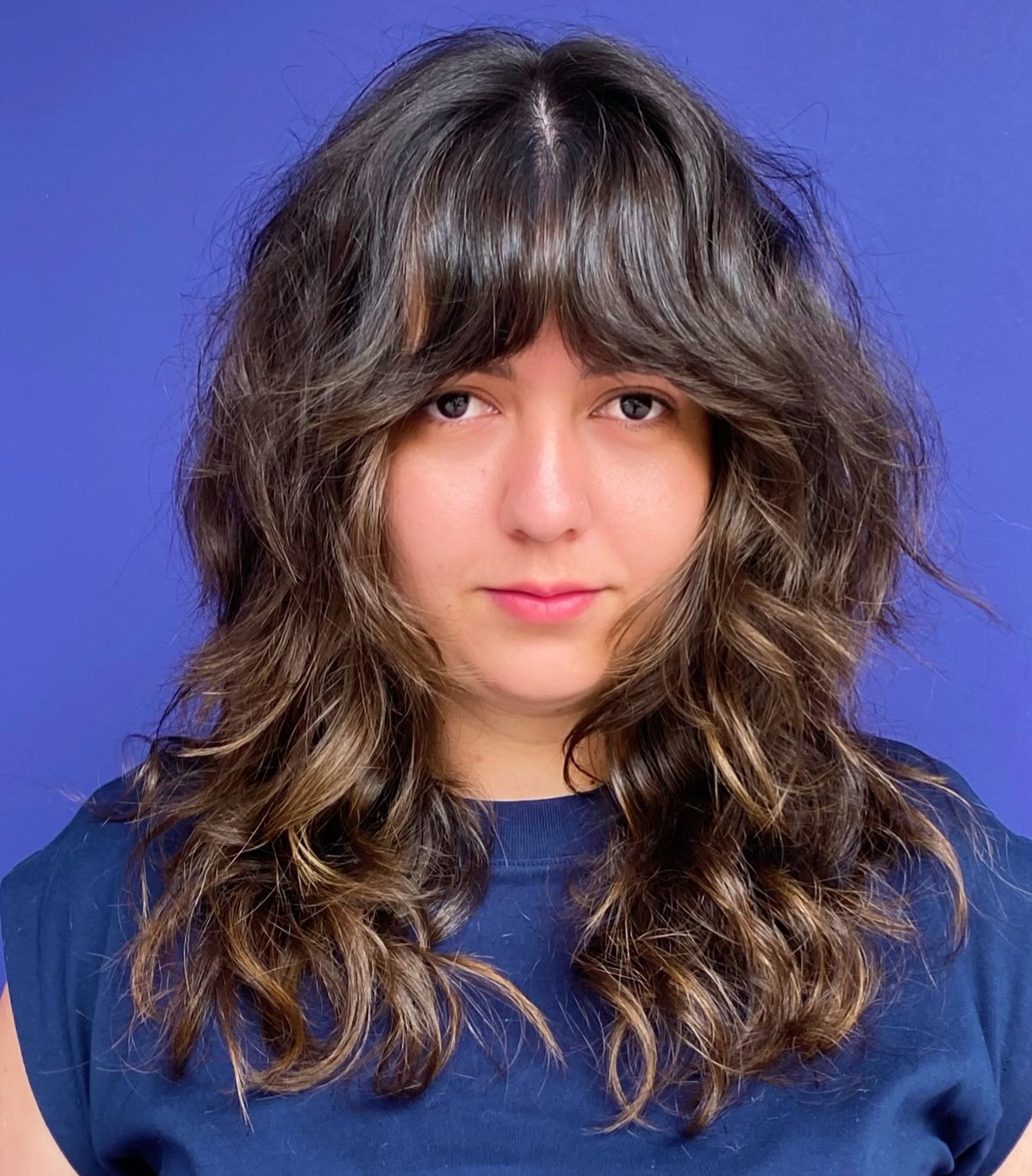 Playful Layered Cut with Soft Waves and Bangs