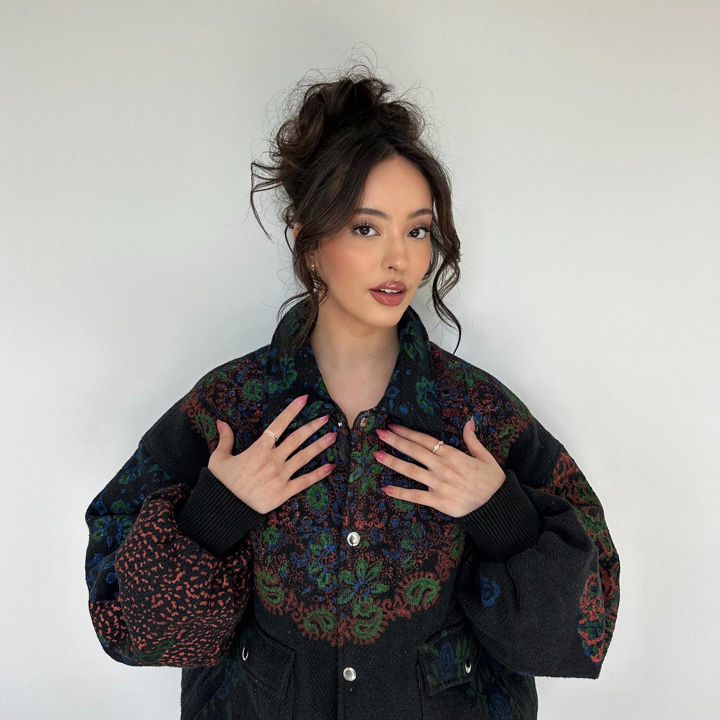 Playful Textured High Bun with Soft Face-Framing Waves