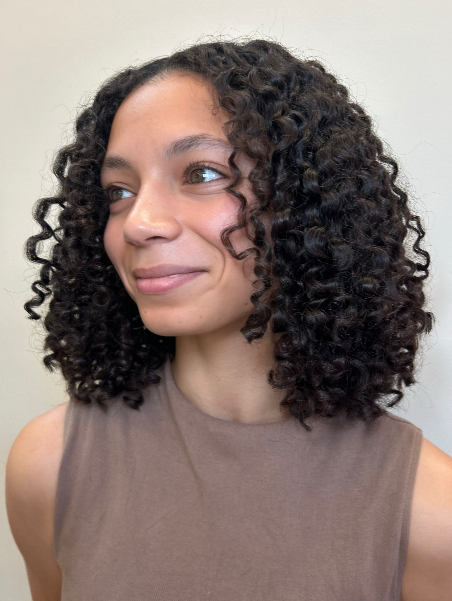 Defined Curly Mid-Length Cut with Natural Bounce