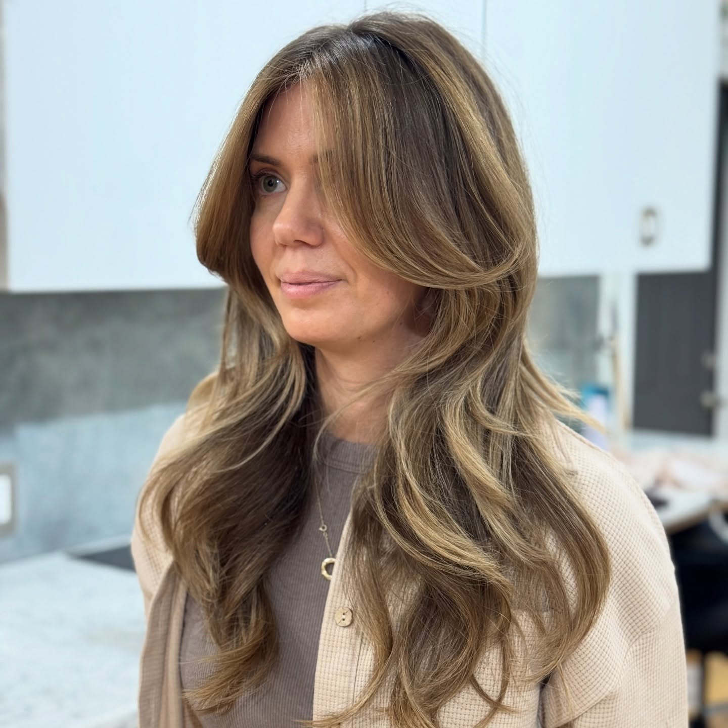 Glamorous Long Layered Cut with Soft Face-Framing Highlights