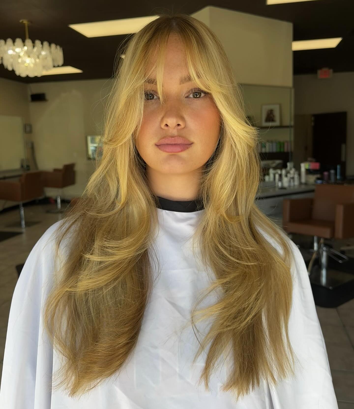 Soft Blonde Layered Hair with Wispy Bangs