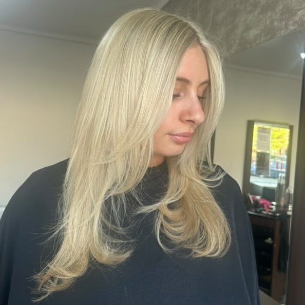 Stylish Long Blonde Layered Cut with Soft Movement