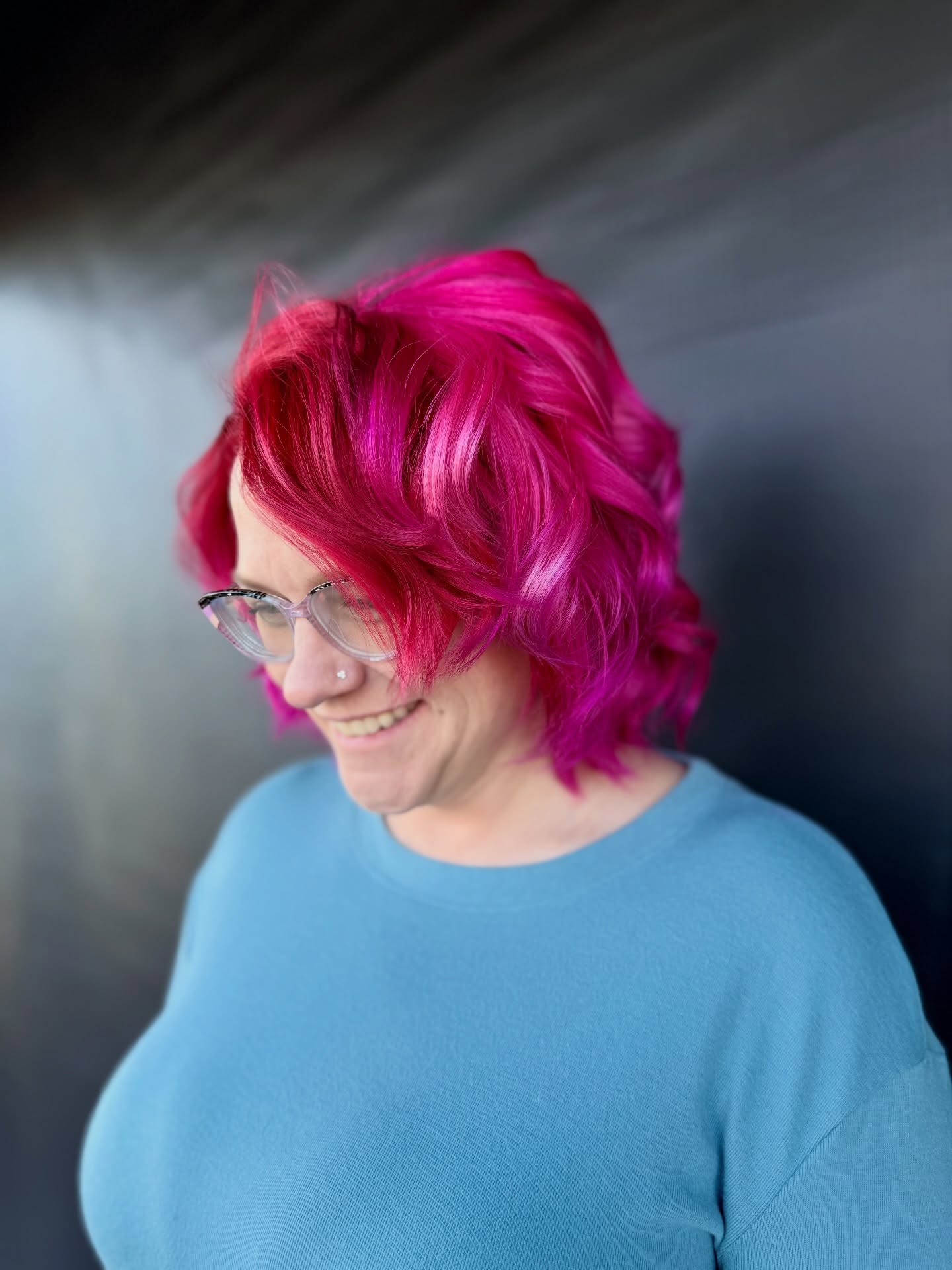 Vibrant Curly Hot Pink Hair with Face-Framing Layers