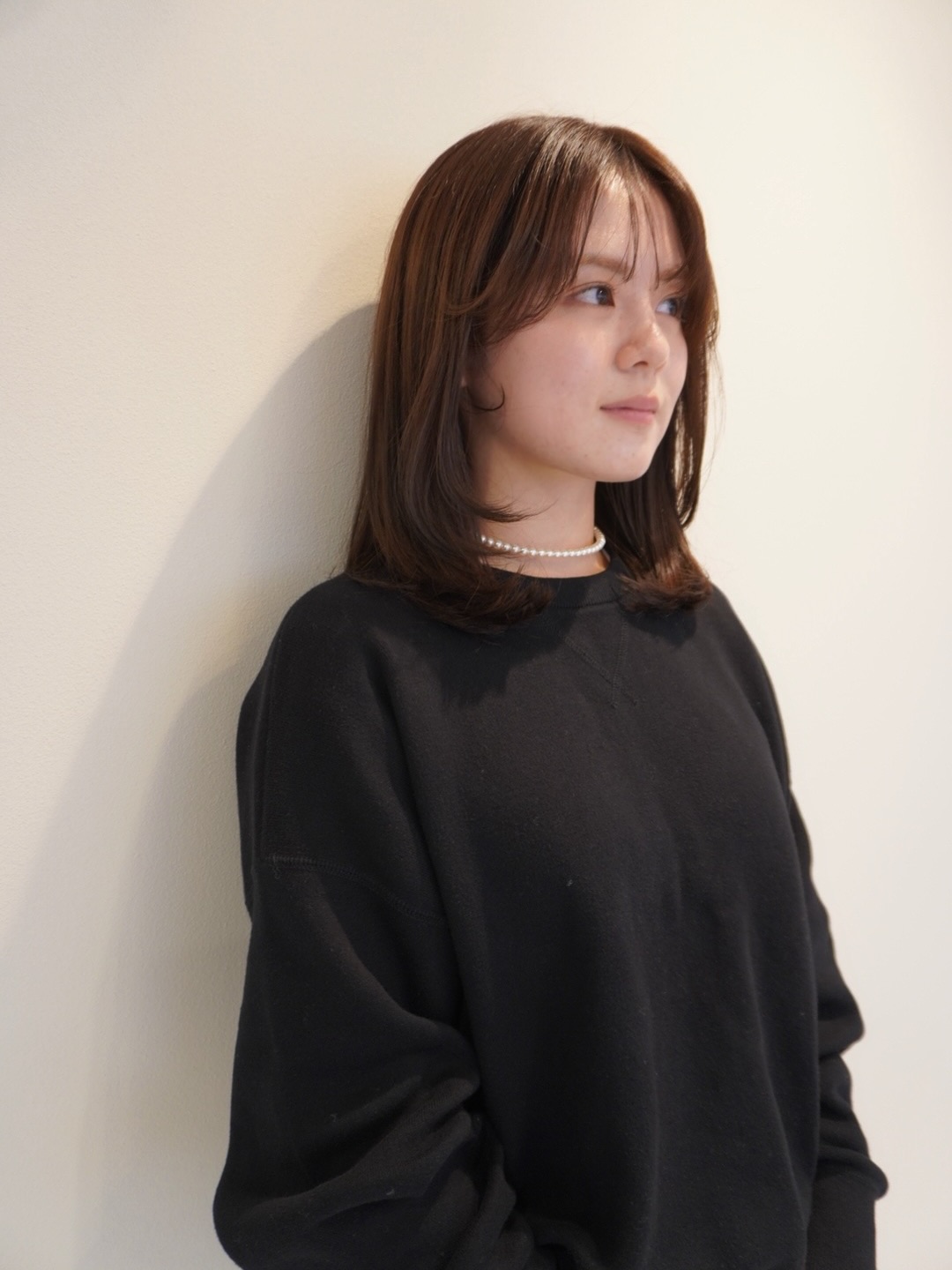 Subtle Layered Medium-Length Cut with Face-Framing Bangs