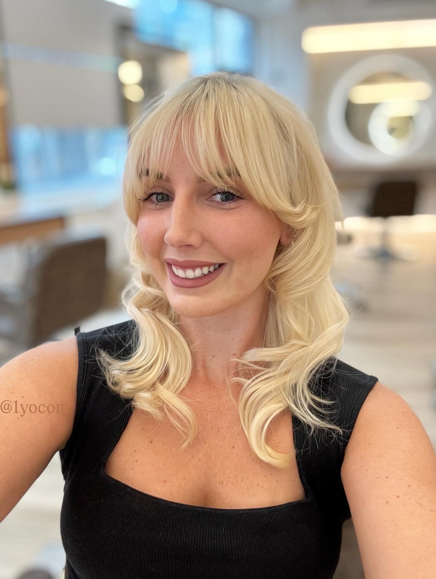 Softly Curled Mid-Length Cut with Face-Framing Bangs