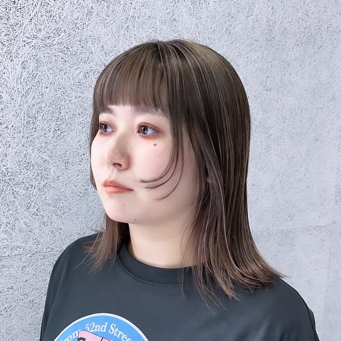 Stylish Mid-Length Haircut with Soft Bangs and Subtle Layers
