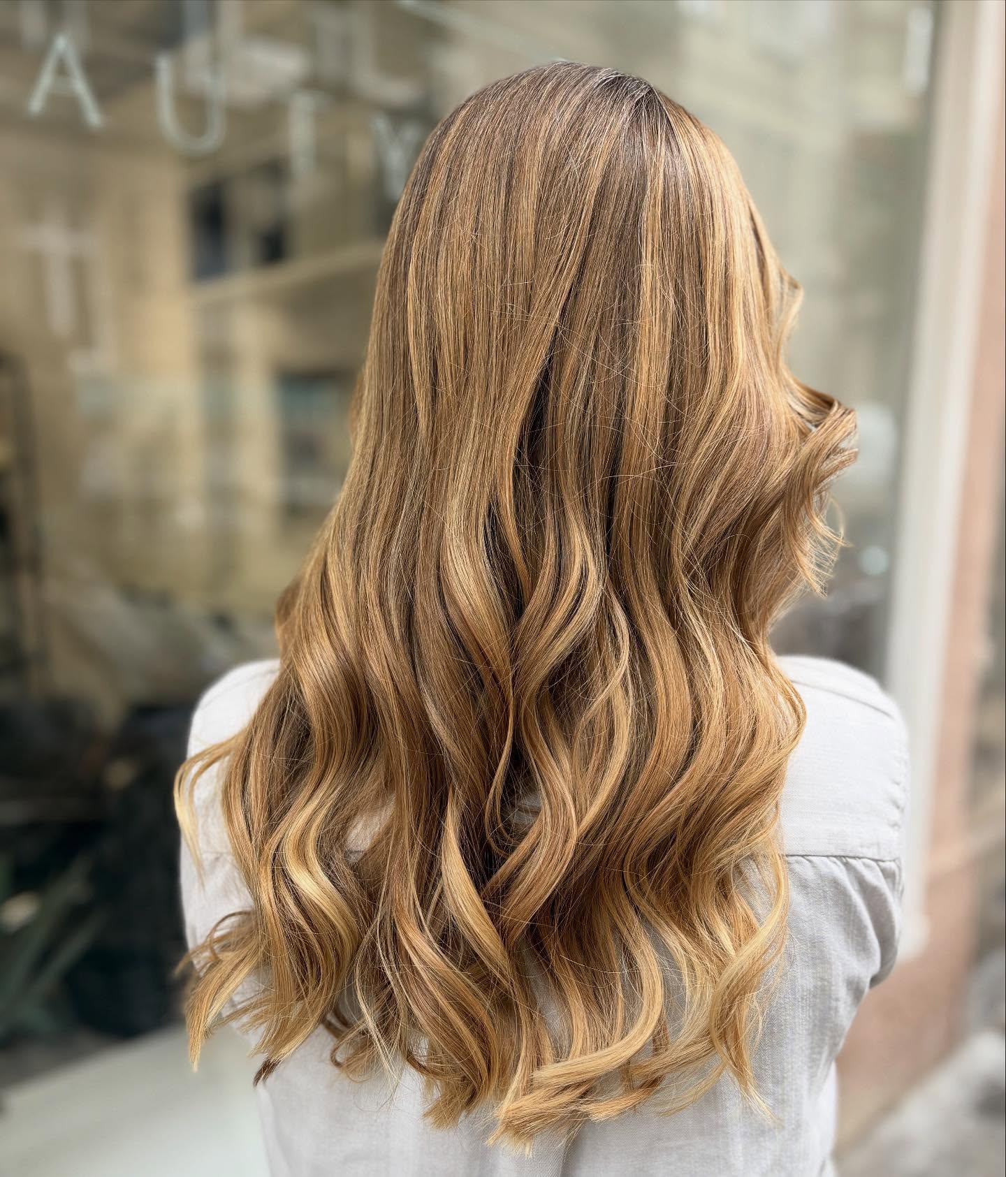Radiant Warm Tone Blonde Balayage with Soft, Defined Waves