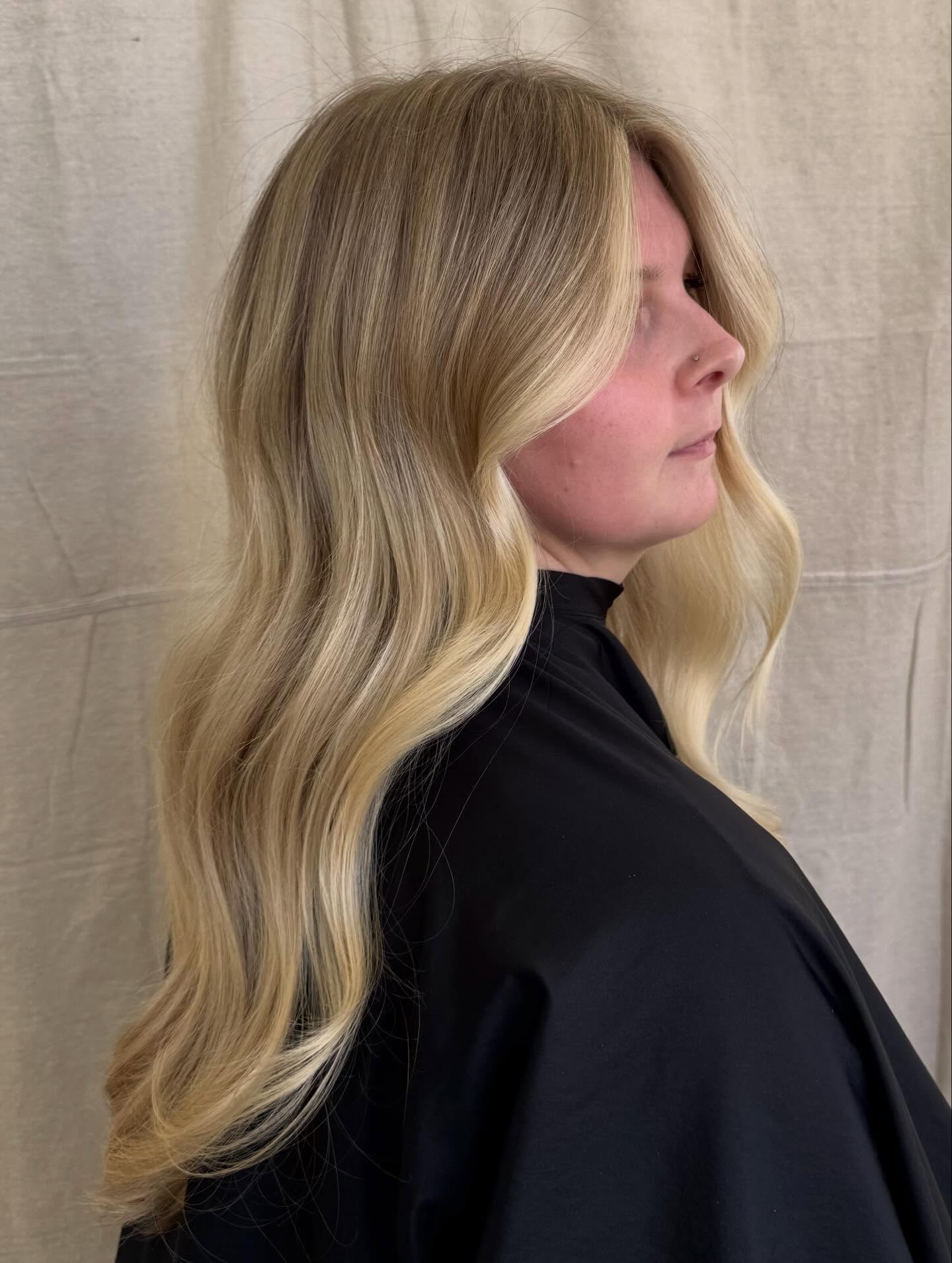 Softly Layered Warm Tone Blonde Balayage with Gentle Waves
