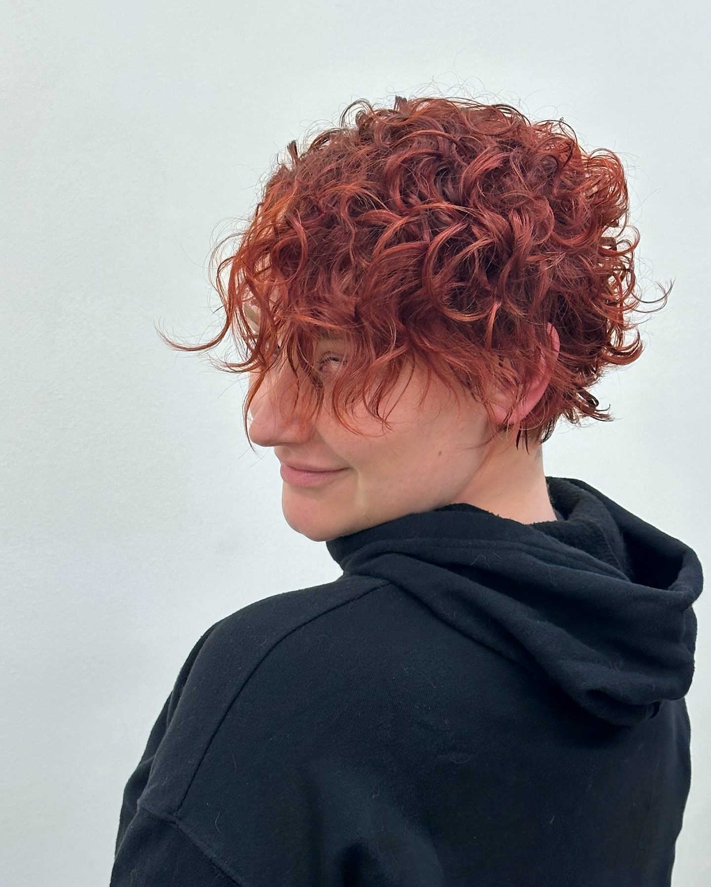 Bold Short Curly Cut with Vibrant Copper Tones