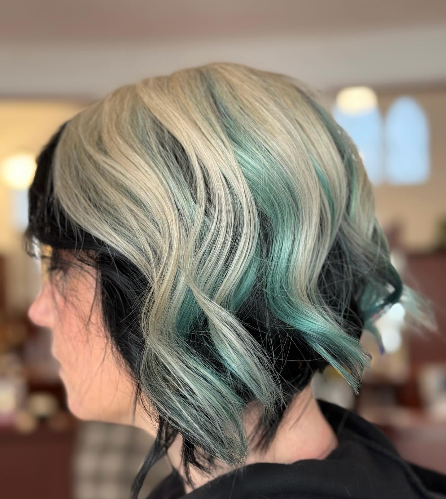 Chic Curly Bob with Teal and Platinum Highlights