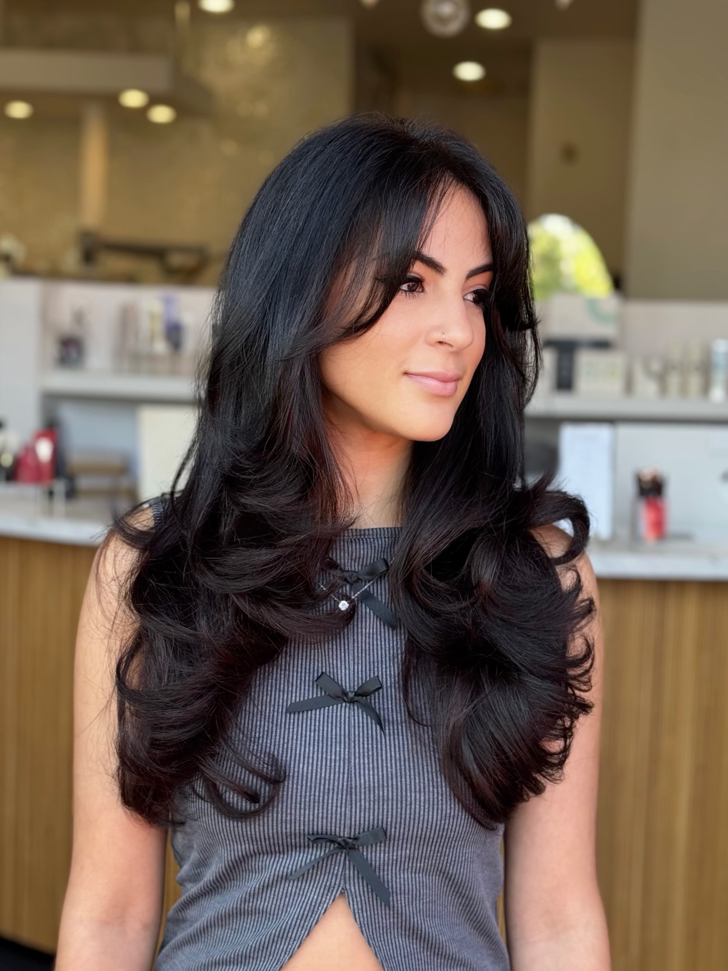 Glamorous Layered Butterfly Haircut with Wispy Bangs