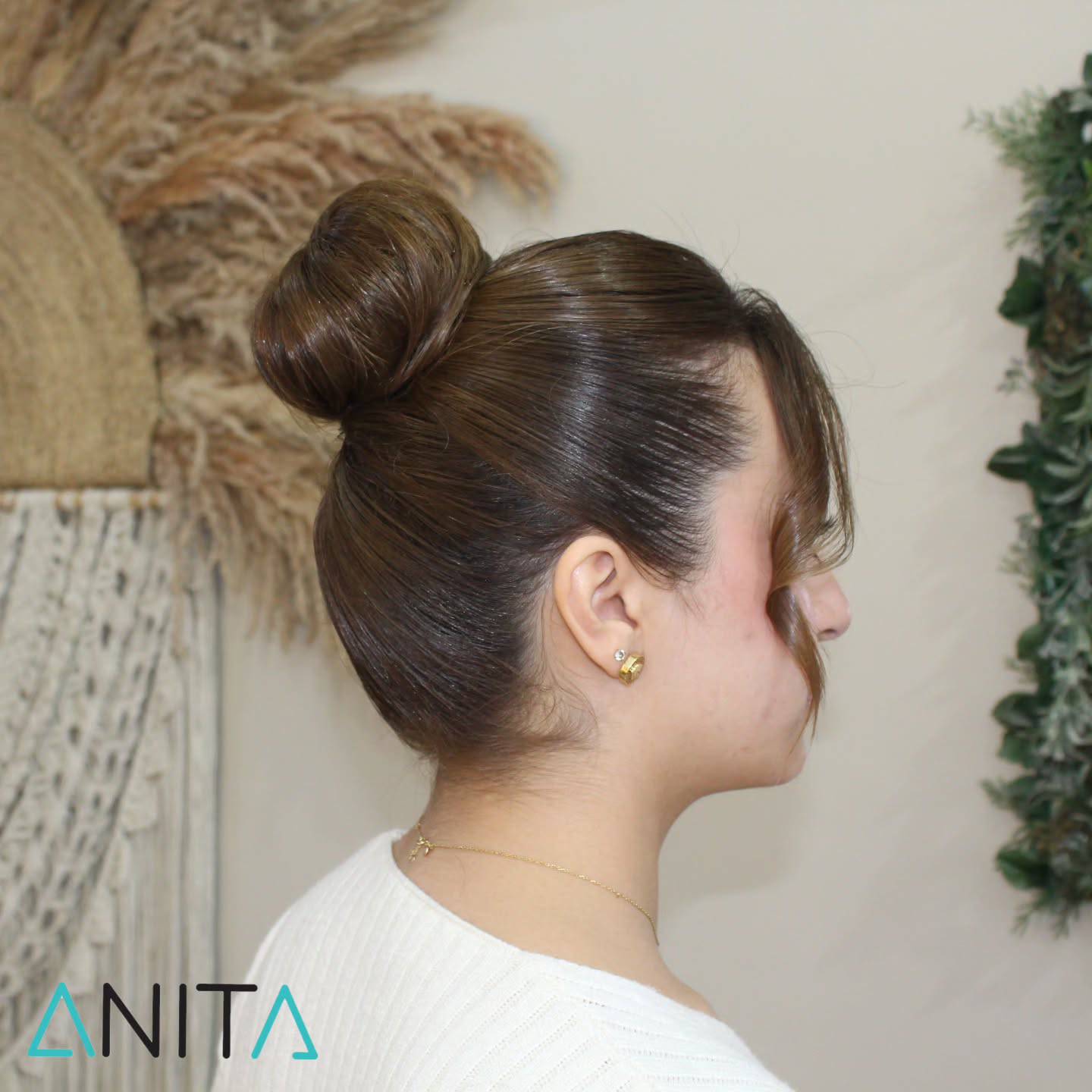 Sleek High Bun with Face-Framing Waves