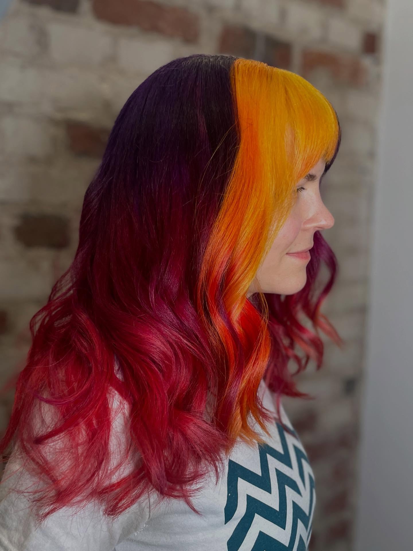 Vibrant Split Color Waves with Bold Bangs