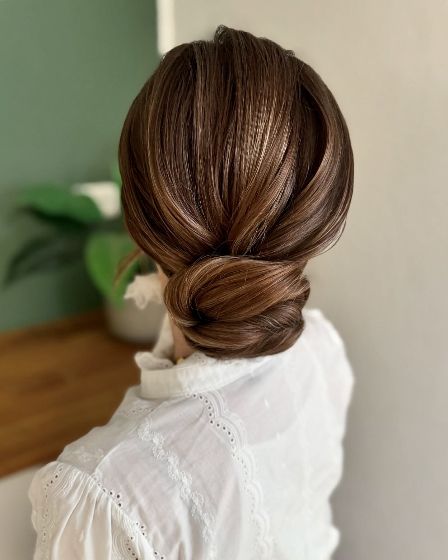 Elegant Swirled Low Bun with Subtle Highlights