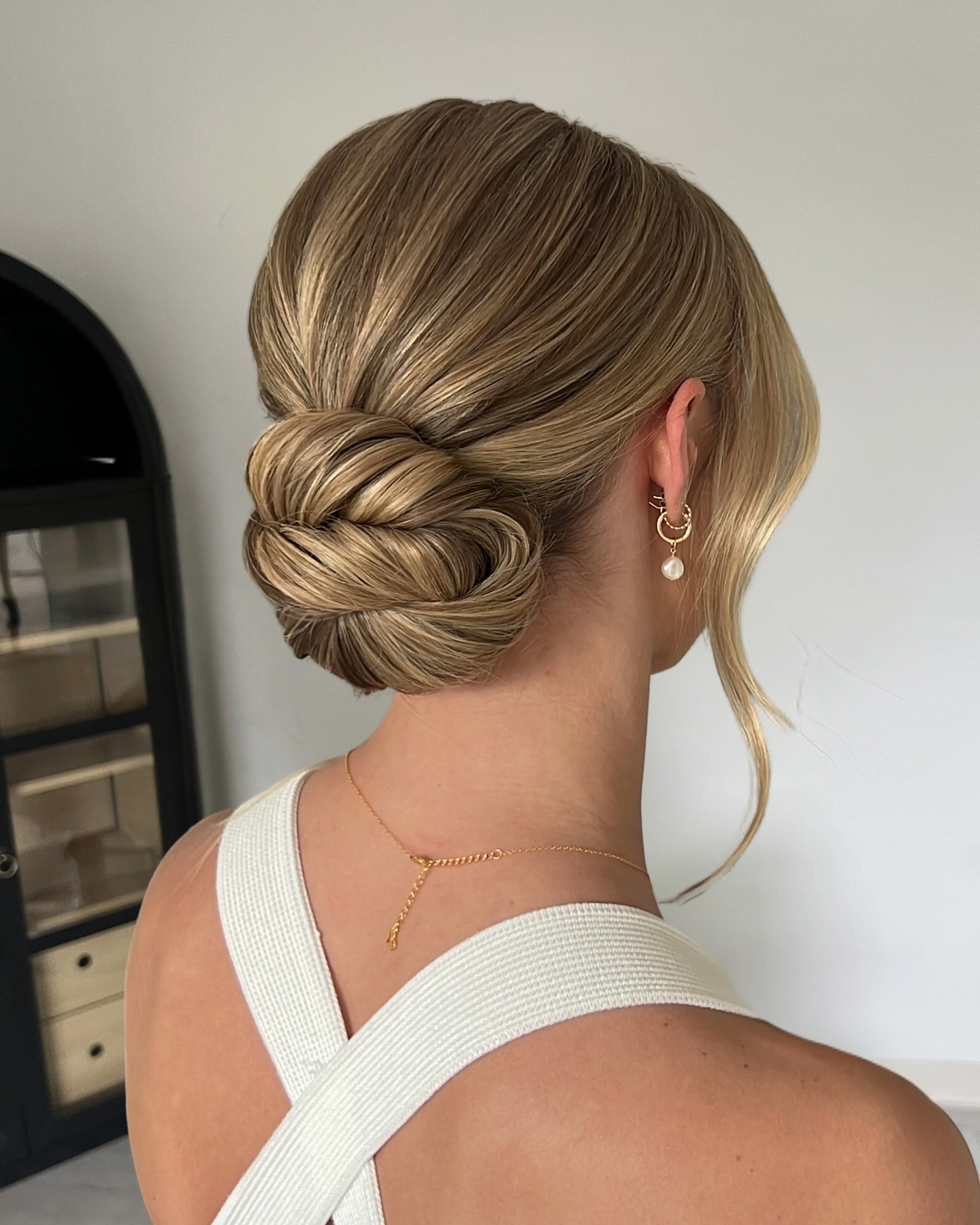 Elegant Twisted Low Bun with Soft Face Framing Strands