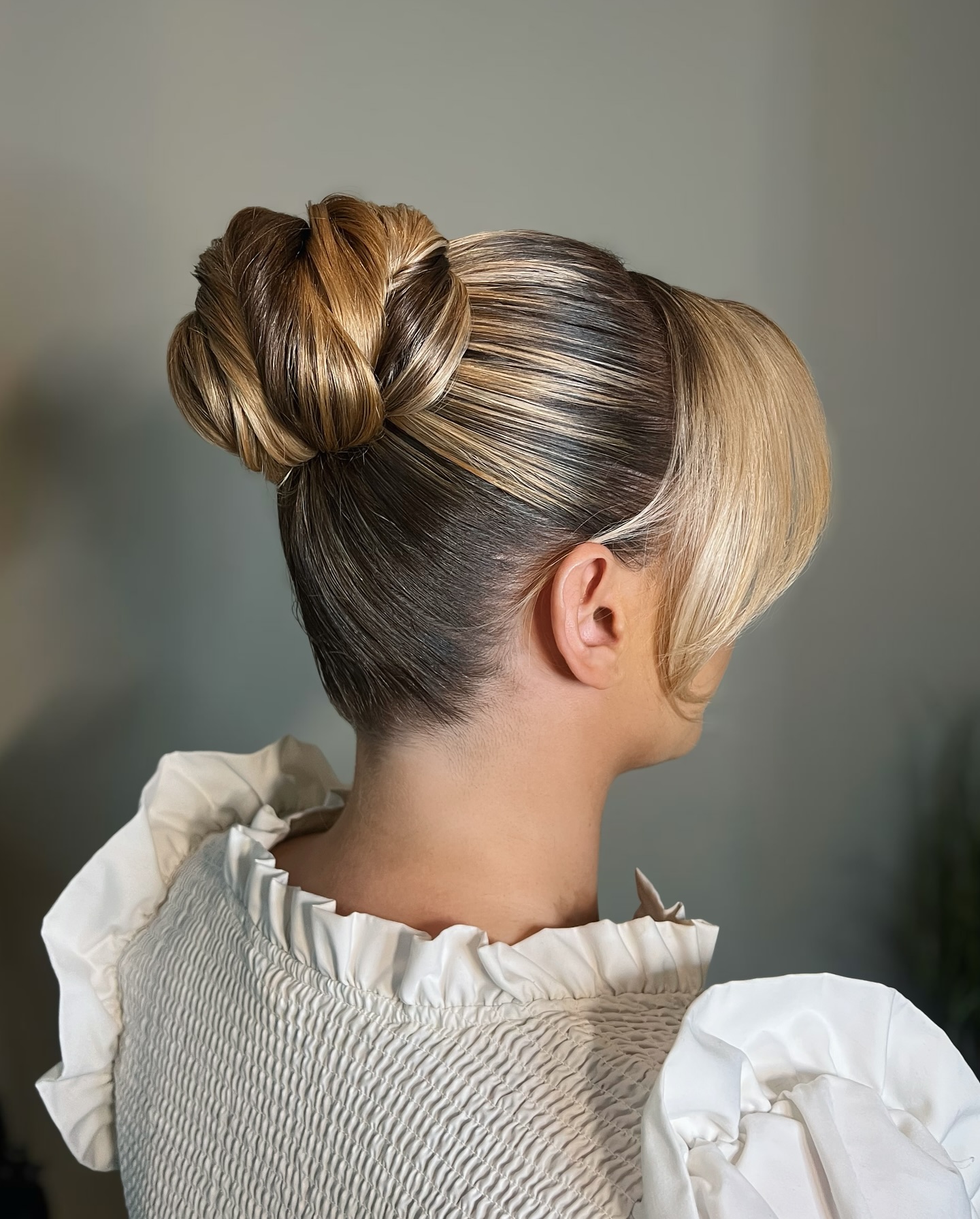Stylish Twisted Bun with Face-Framing Layers