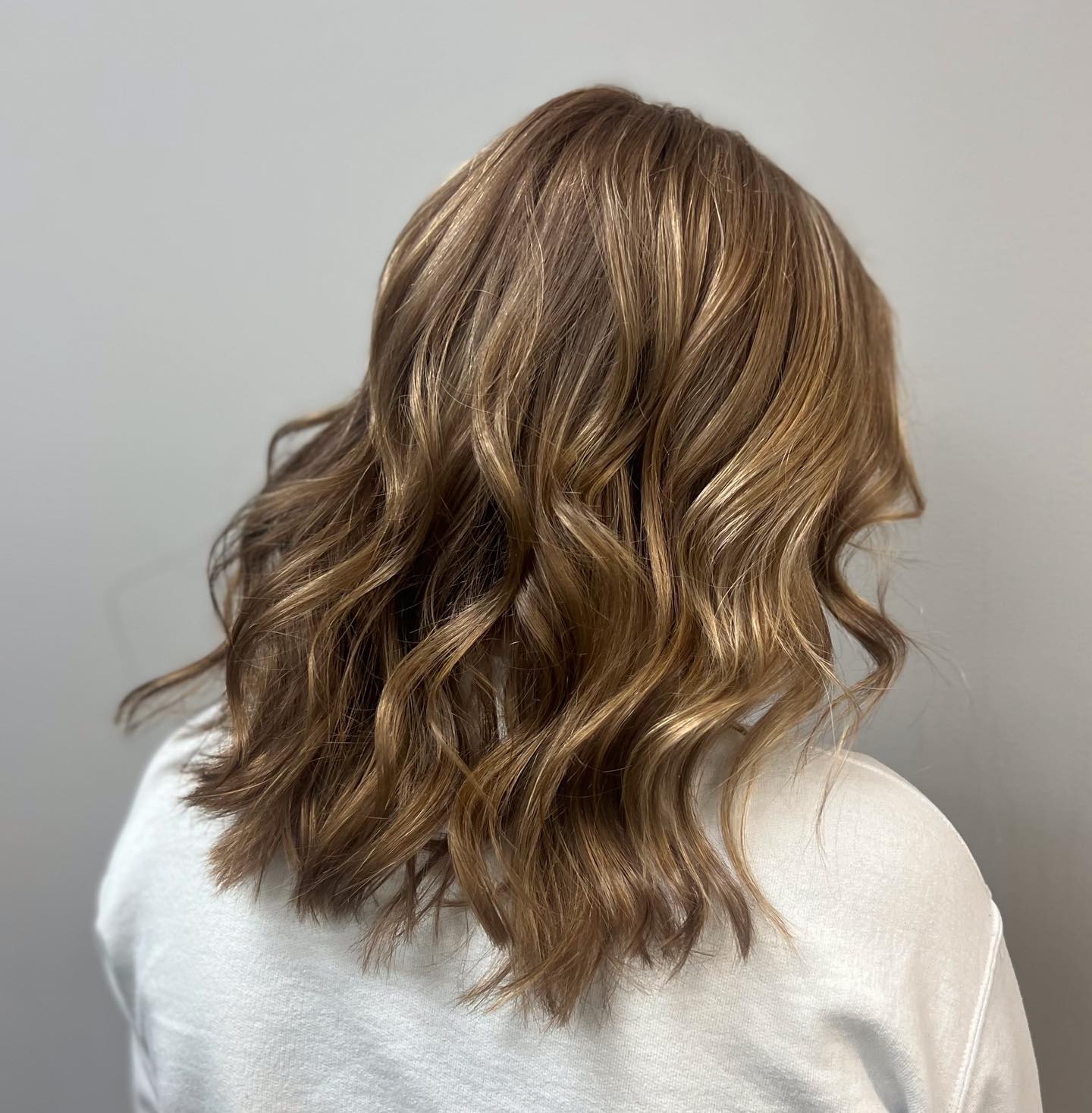 Textured Mid-Length Waves with Subtle Balayage