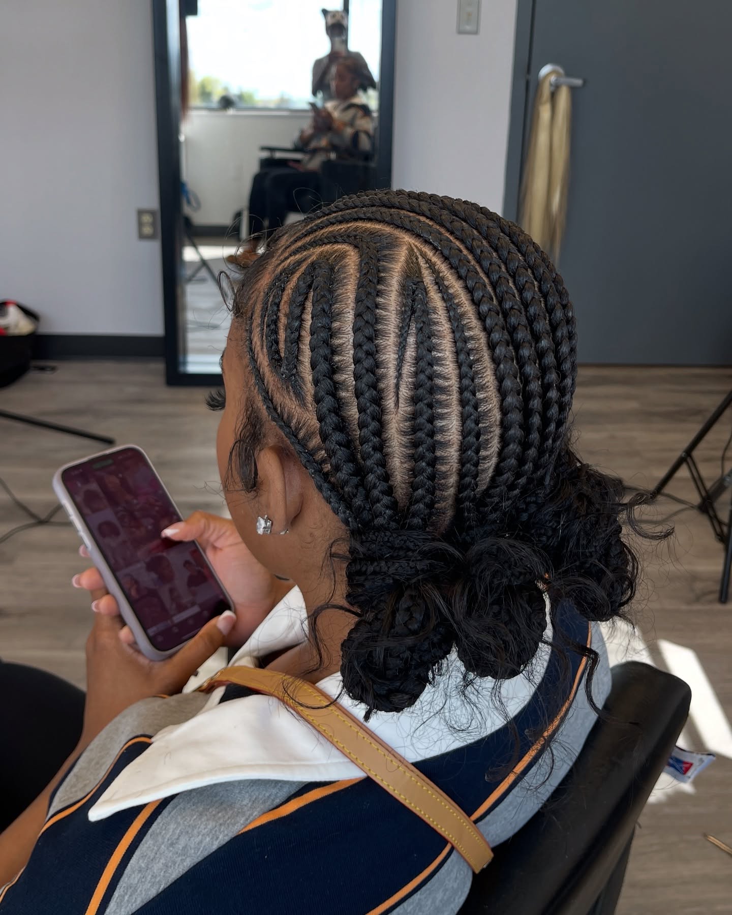 Stylish Braided Updo with Defined Cornrow Patterns