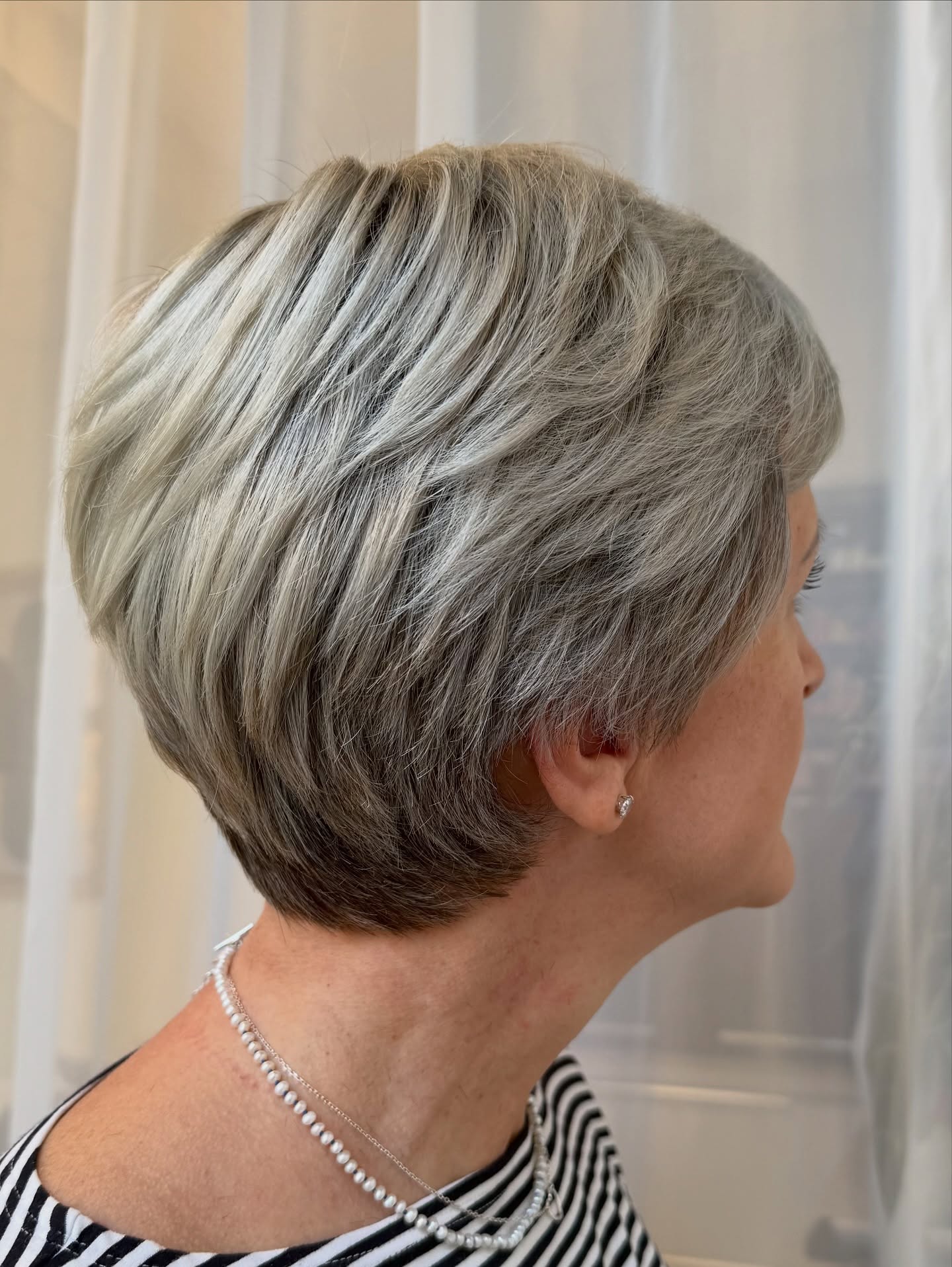 Modern Textured Gray Pixie with Subtle Blonde Highlights