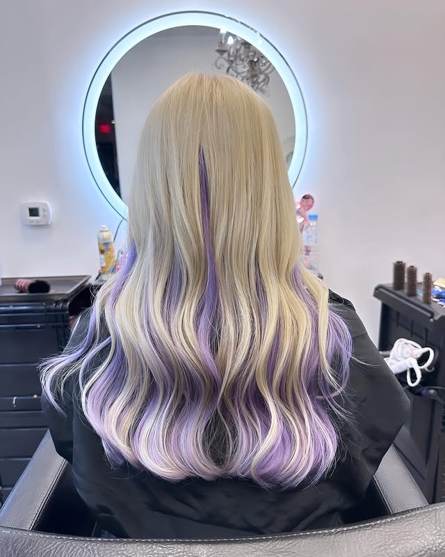 long wavy hair with peekaboo purple highlights