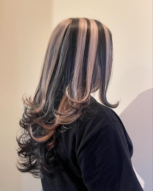 Dynamic Skunk Stripe Hair Color with Luscious Layers