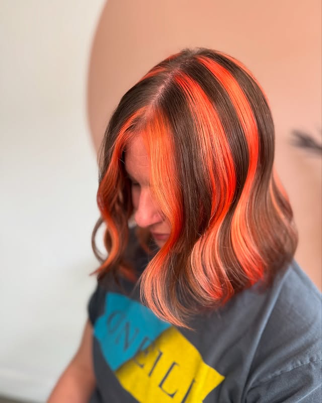 Vibrant Skunk Stripe Hair Color with Soft Waves