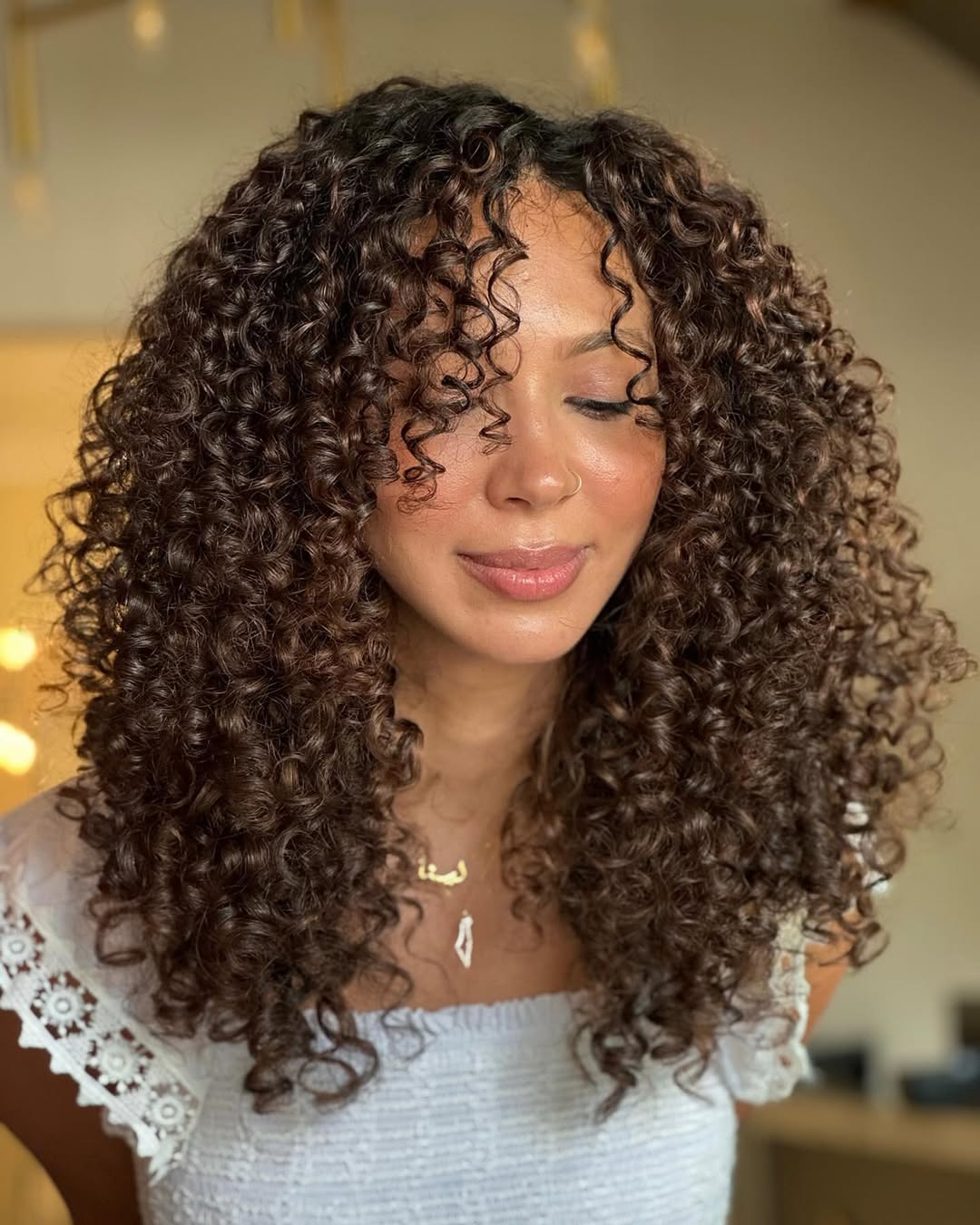 Dynamic Curly Choppy Layers with Rich Caramel Highlights