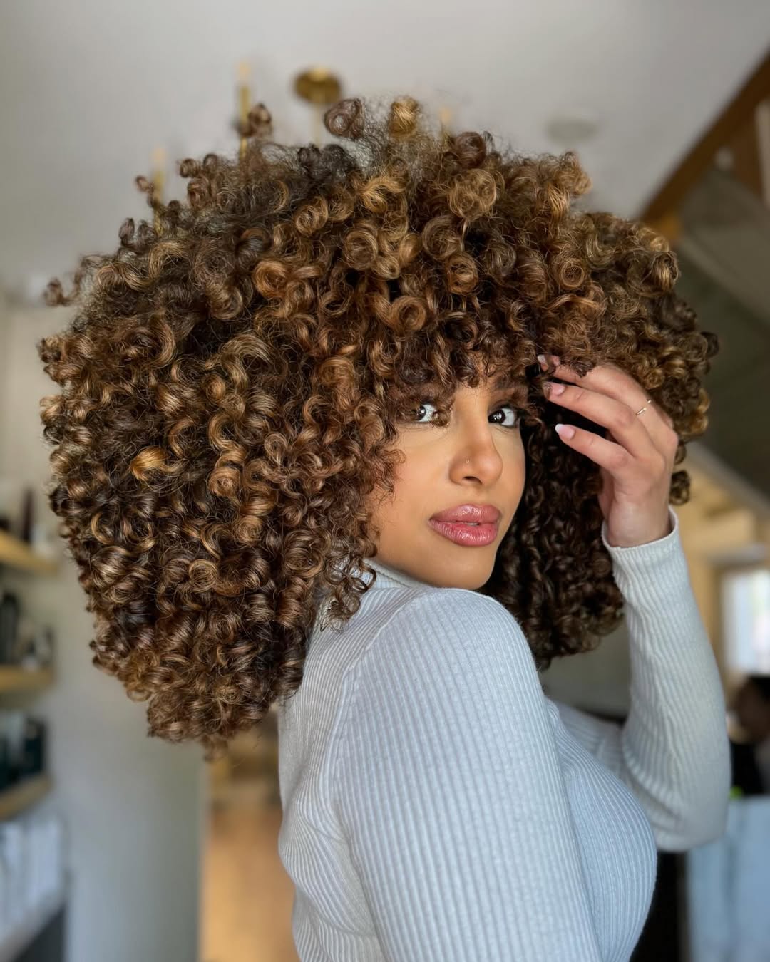 Voluminous Choppy Curly Layers with Warm Highlights
