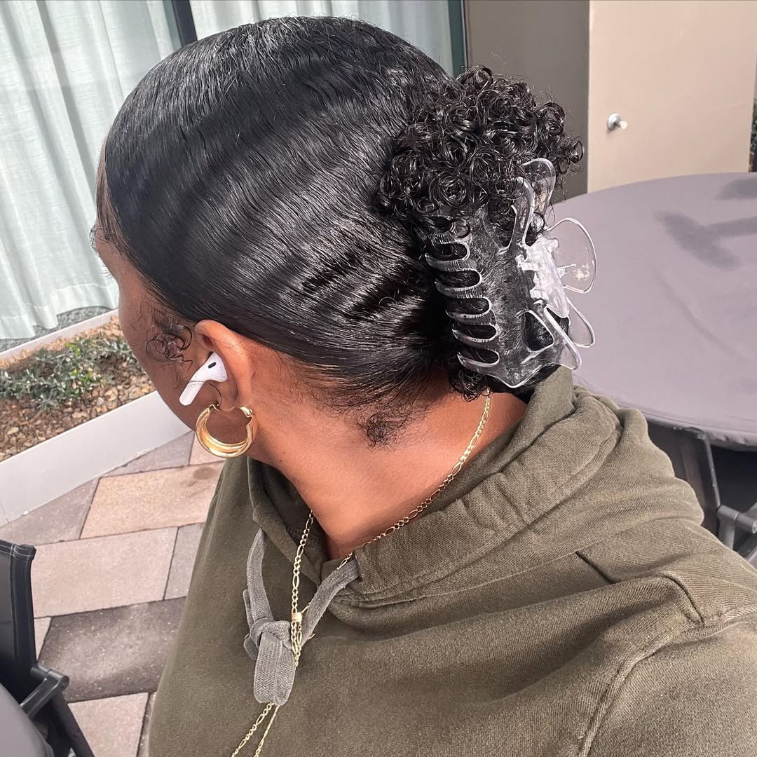 Sleek Low Chignon with Defined Curls