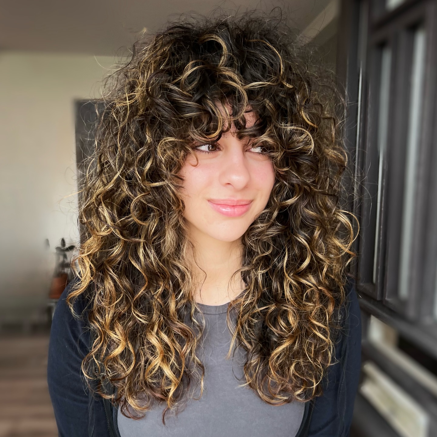 chic curly hair with heavy bangs