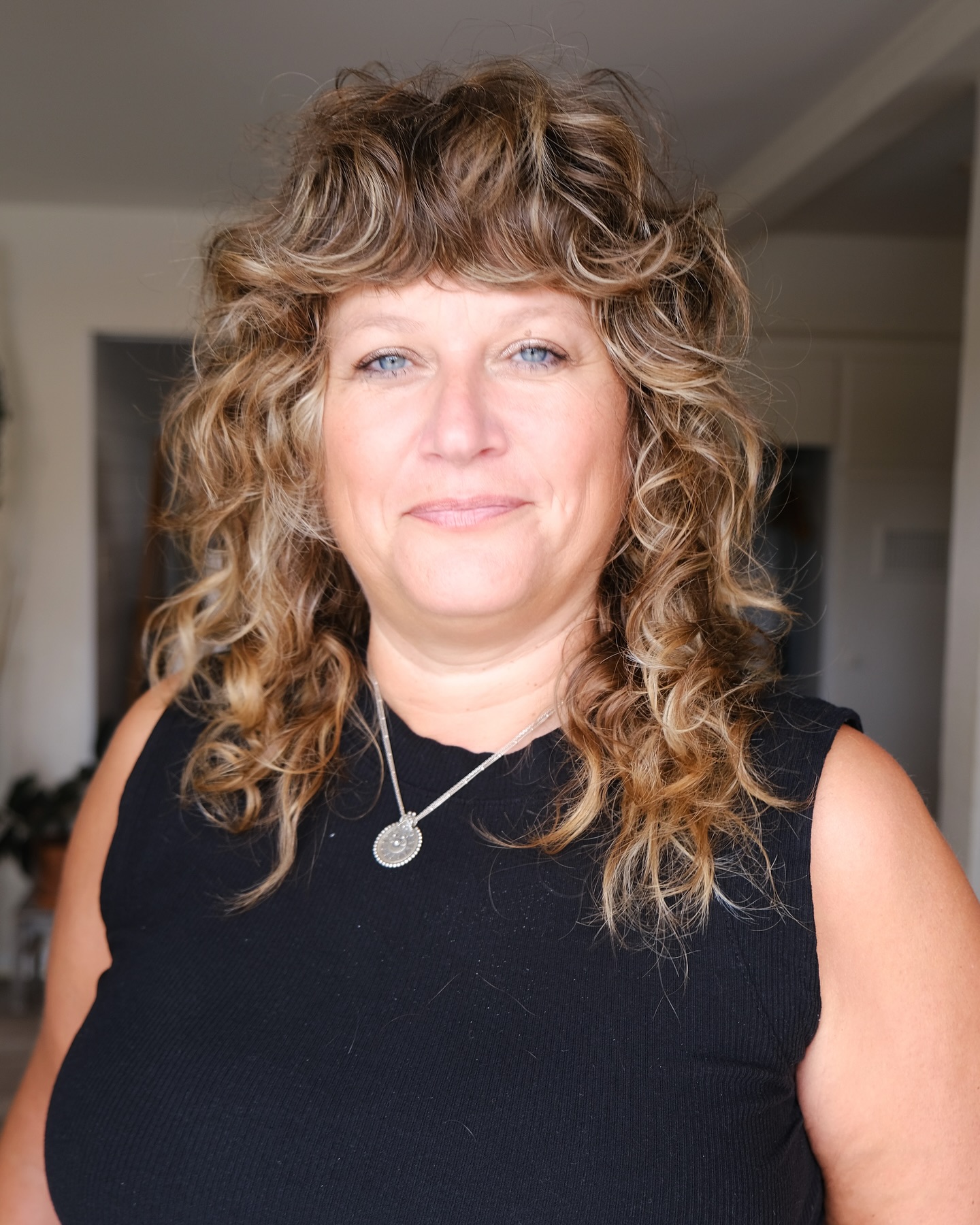 Curly Layered Haircut with Bold Bangs