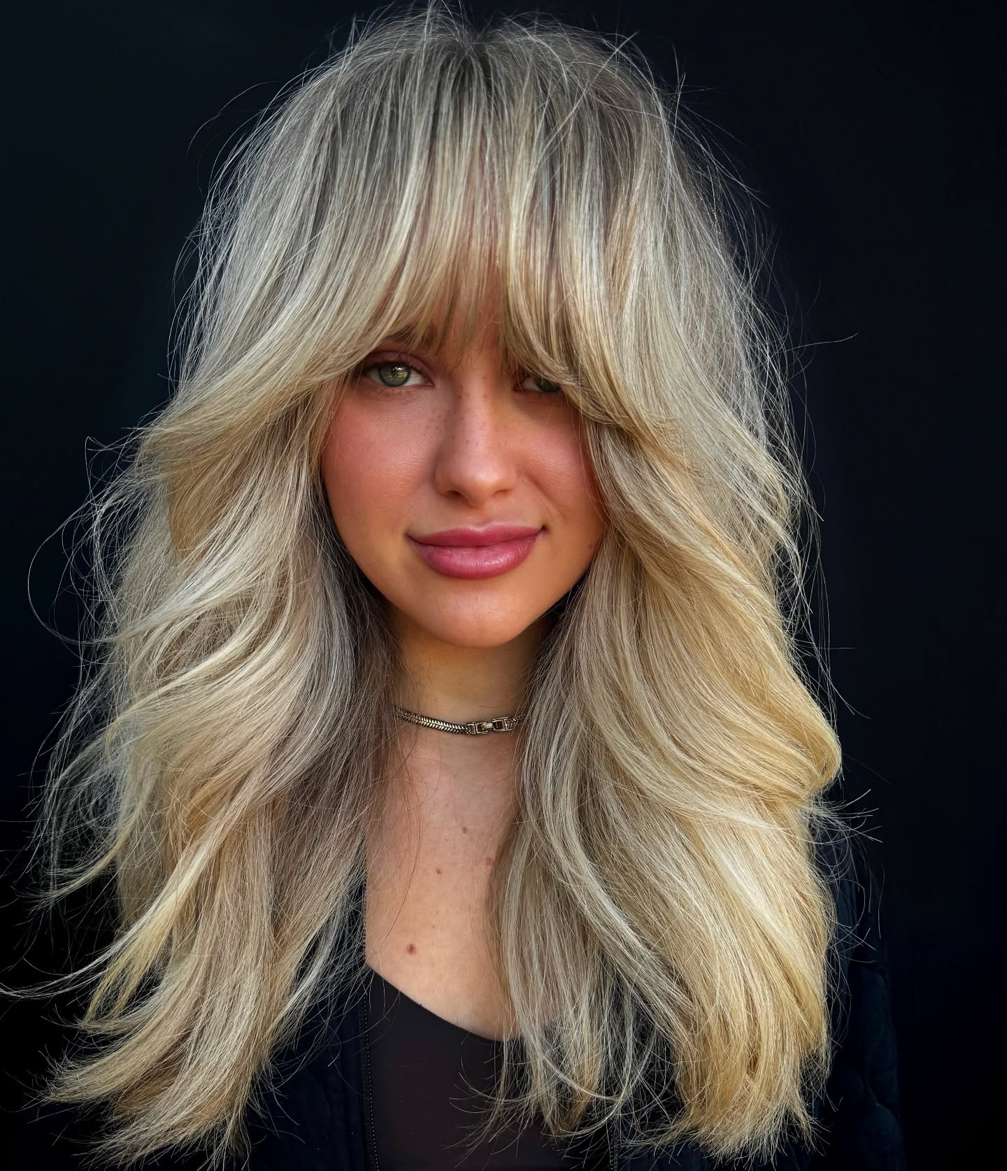 Voluminous Layered Hair with Bold Bangs