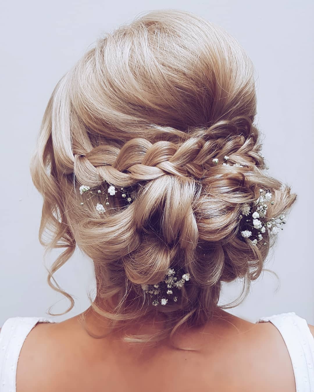 Chic Braided Updo with Floral Accents