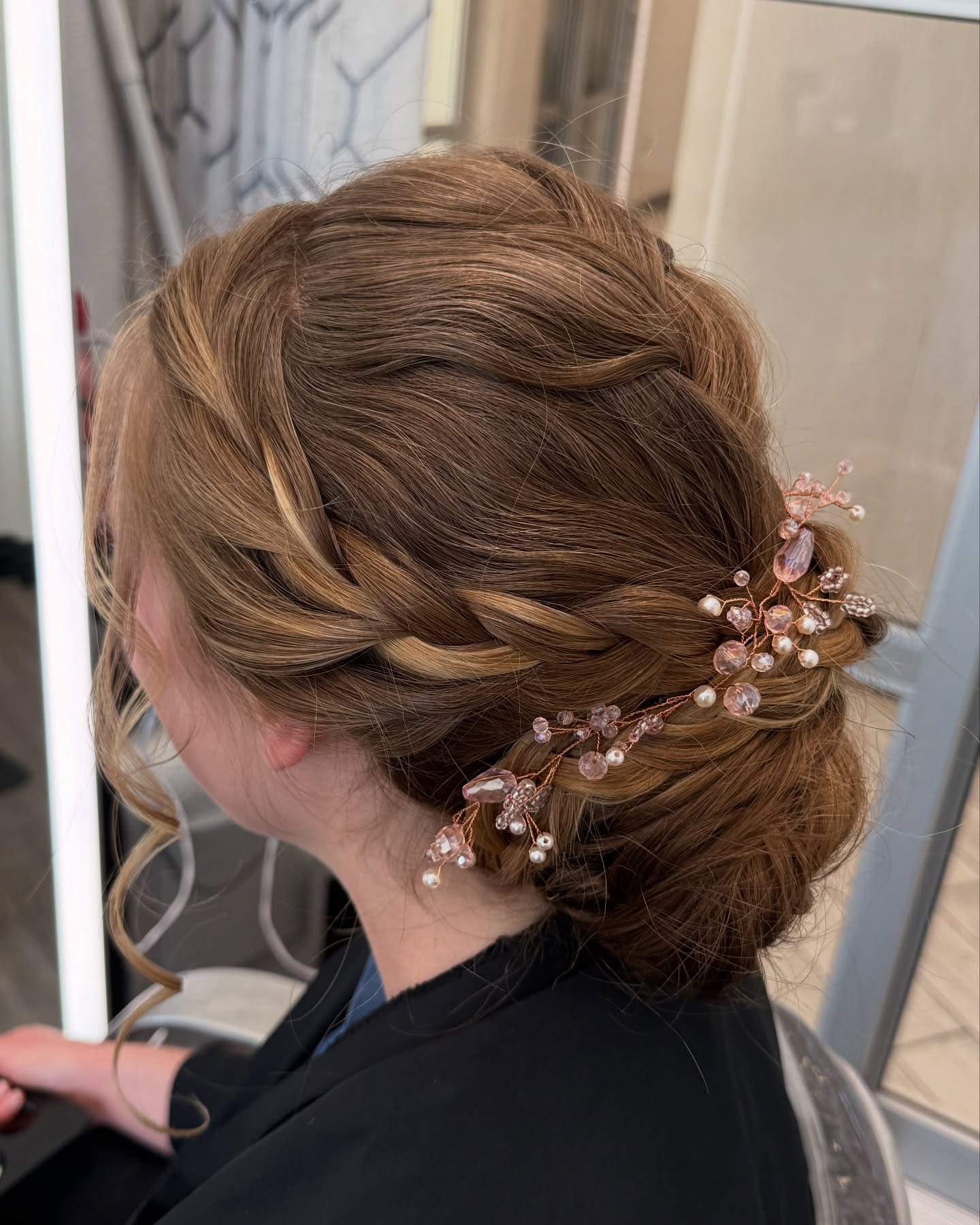 Elegant Braided Updo with Intricate Floral Accents