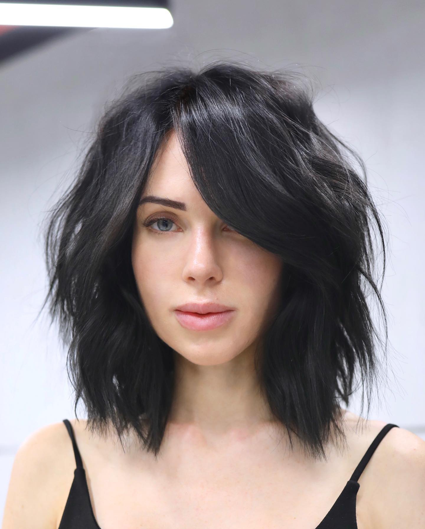 chic choppy layered bob with side swept bangs