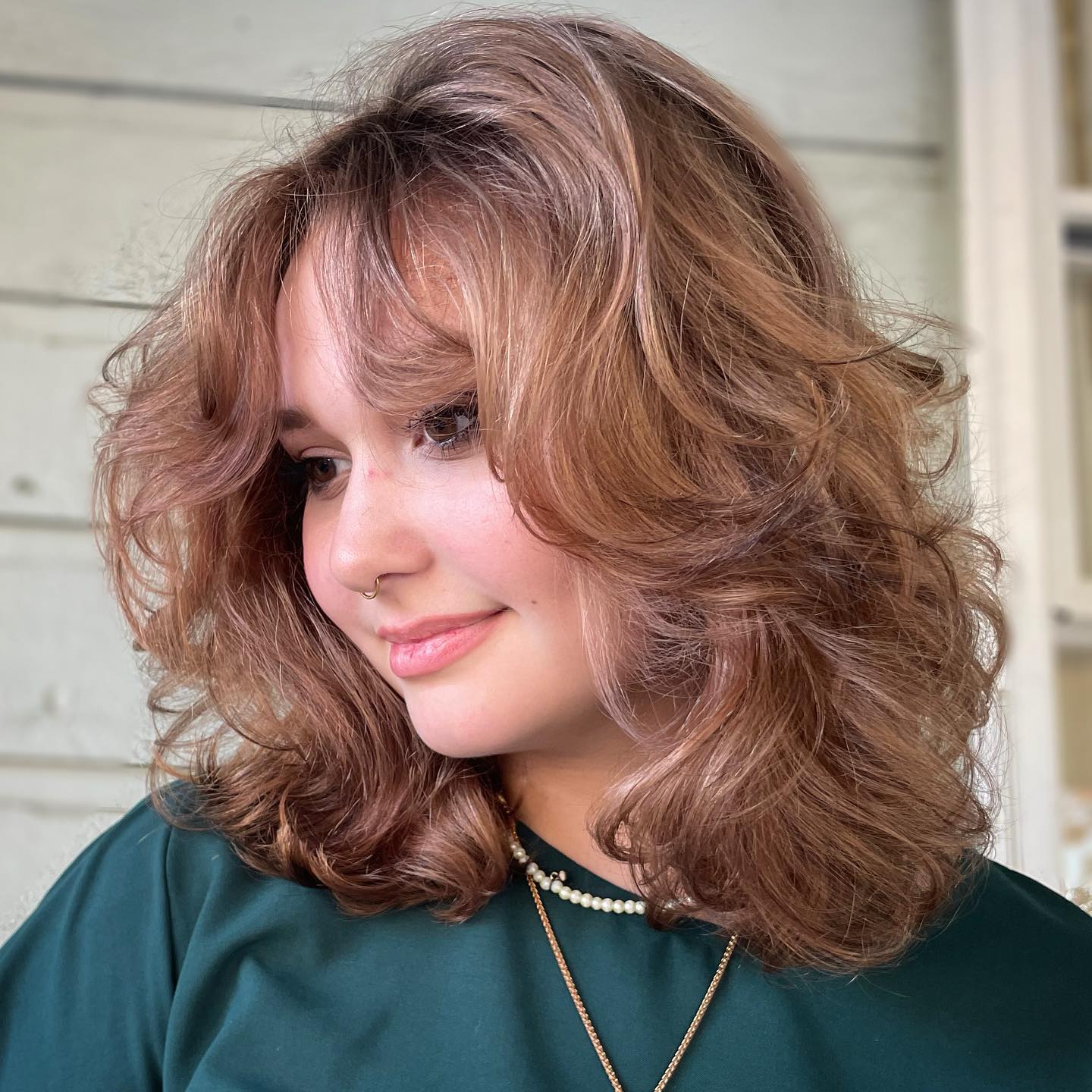 Chic Layered Curly Cut with Soft Bangs
