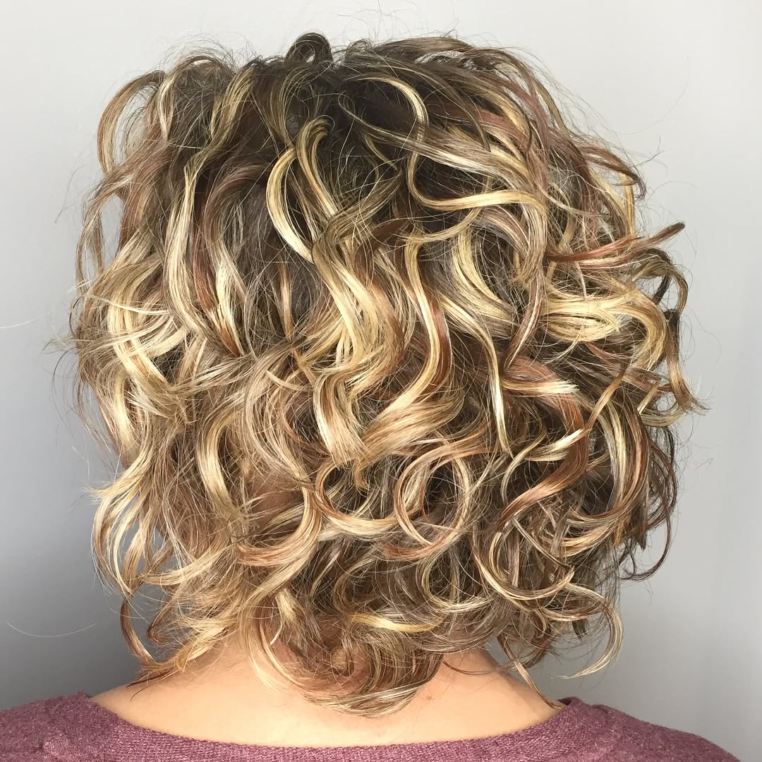 textured curly bob with highlights
