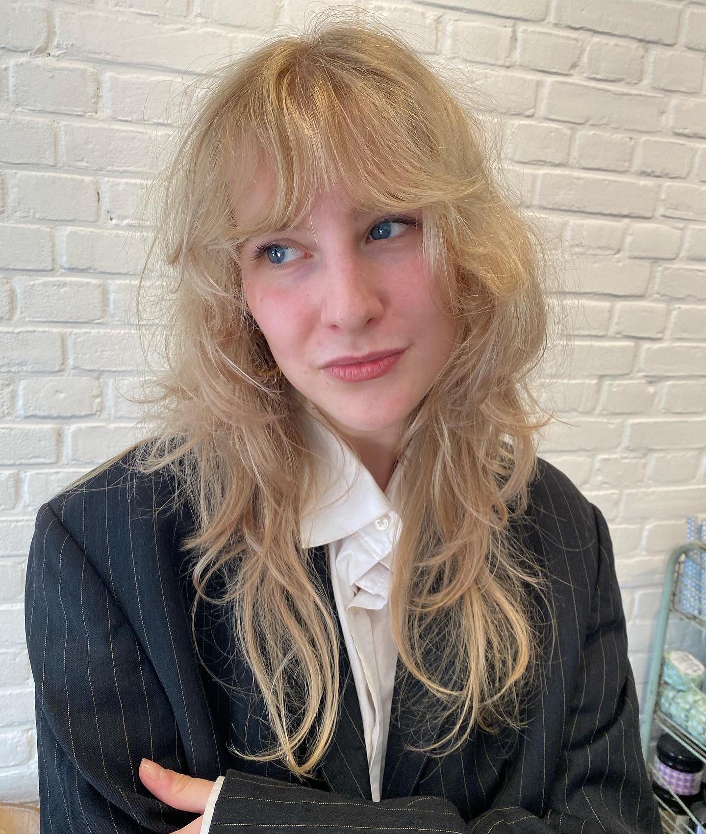 Effortlessly Chic Feathered Bangs with Luscious Layers