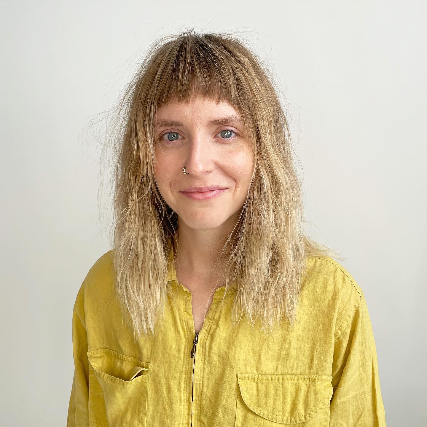 Effortlessly Chic Textured Bangs with Wavy Layers
