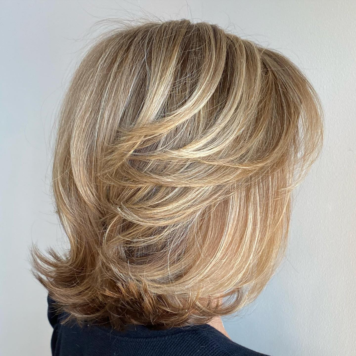 Layered Feathered Bob with Soft Blonde Highlights